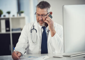 A doctor sitting talking on the phone