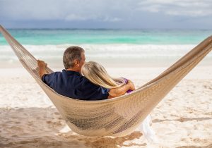 Man and woman sitting in hammock