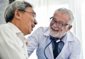 Smiling doctor with happy patient