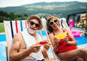 Senior man and woman safely enjoying the sun